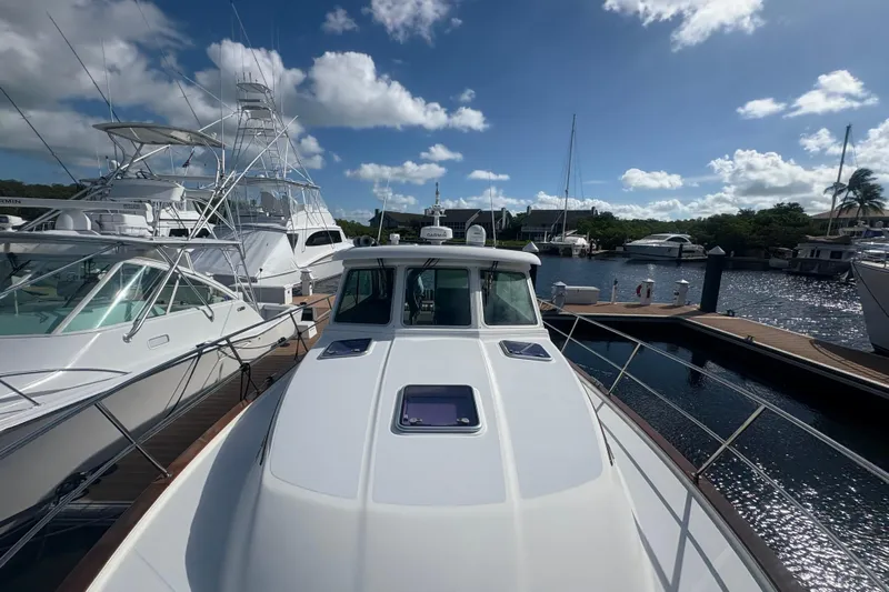  Yacht Photos Pics 2016 Sabre 38 Salon Express yacht docked at marina under blue sky.