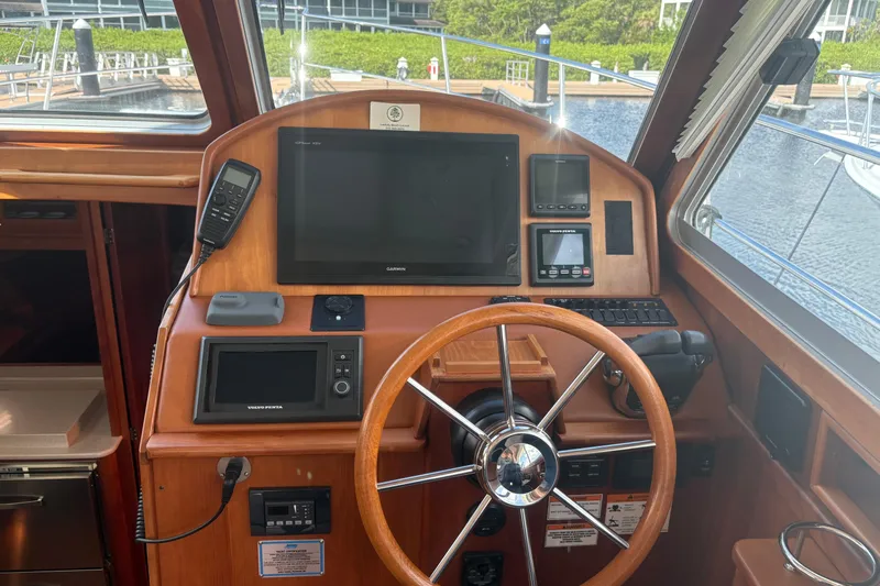  Yacht Photos Pics Helm of 2016 Sabre 38 Salon Express with navigation equipment and wooden steering wheel.