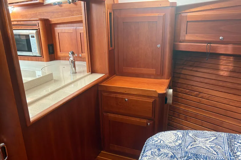  Yacht Photos Pics Interior of 2016 Sabre 38 Salon Express with wood cabinetry and modern kitchen amenities.