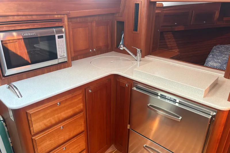  Yacht Photos Pics 2016 Sabre 38 Salon Express galley with microwave, sink, and stainless steel appliances.