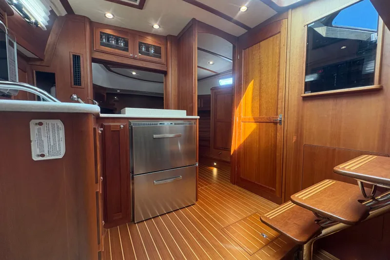 Yacht Photos Pics Interior of 2016 Sabre 38 Salon Express yacht with wooden finishes and stainless steel appliances.