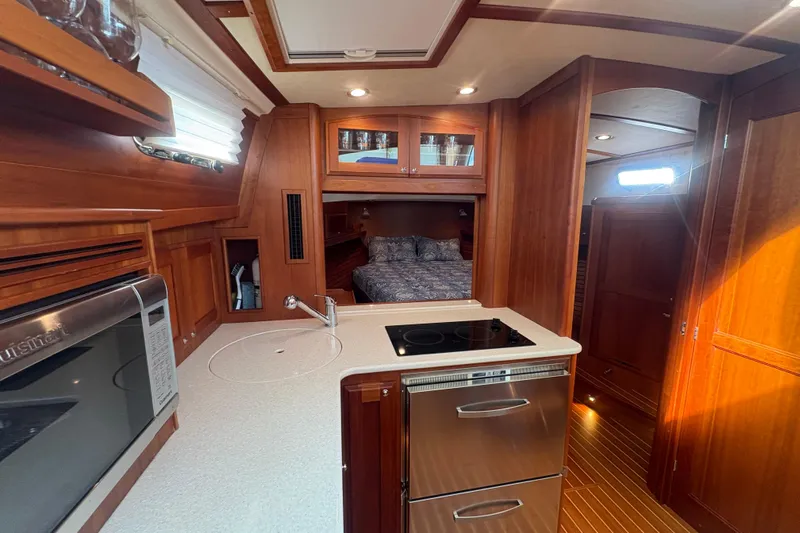  Yacht Photos Pics Interior of 2016 Sabre 38 Salon Express yacht with kitchen and cozy bedroom.