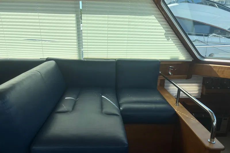  Yacht Photos Pics Interior of 2016 Sabre 38 Salon Express with blue seating and window blinds.