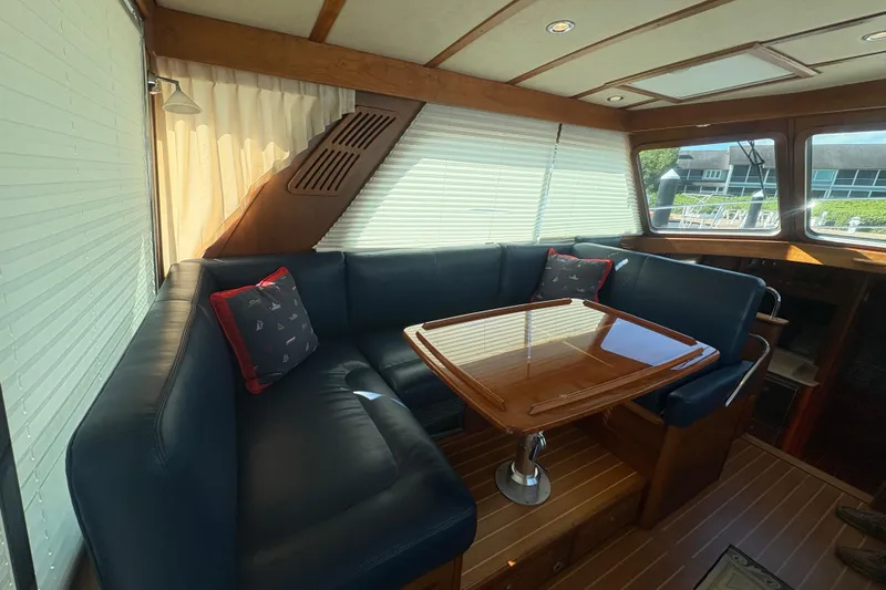  Yacht Photos Pics Interior of 2016 Sabre 38 Salon Express with leather seating and wooden table.