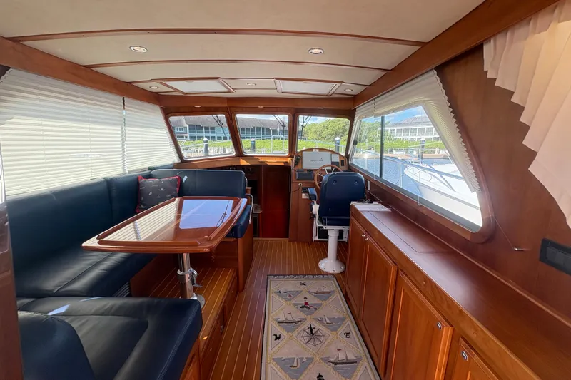  Yacht Photos Pics 2016 Sabre 38 Salon Express interior with wood finish, dining area, and helm station.
