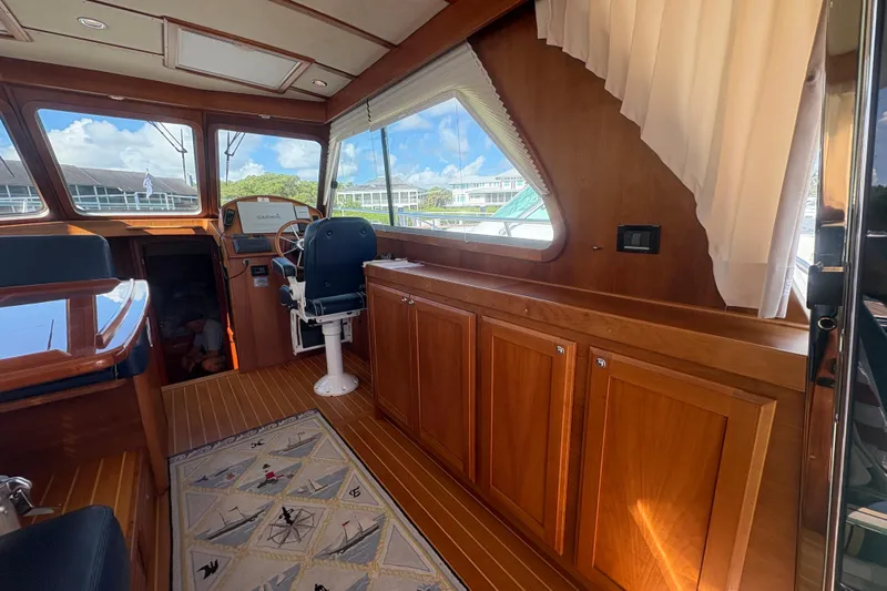  Yacht Photos Pics Interior of 2016 Sabre 38 Salon Express with wooden cabinetry and helm station.