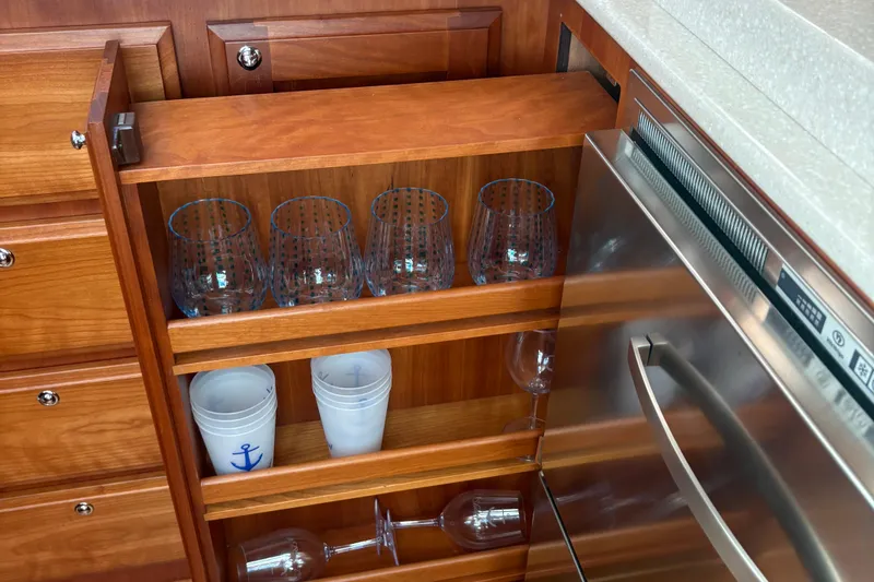  Yacht Photos Pics Wooden cabinet with glassware and cups on a Sabre 38 Salon Express yacht, 2016 model.