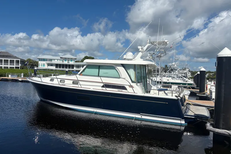  Yacht Photos Pics 2016 Sabre 38 Salon Express yacht docked at marina under blue sky.