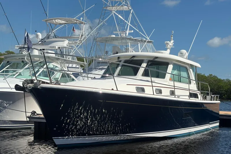 Yacht Photos Pics 2016 Sabre 38 Salon Express yacht docked in marina under clear blue sky.