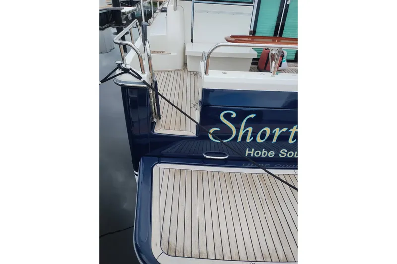  Yacht Photos Pics 2016 Sabre 38 Salon Express yacht with teak deck and blue hull at dock.