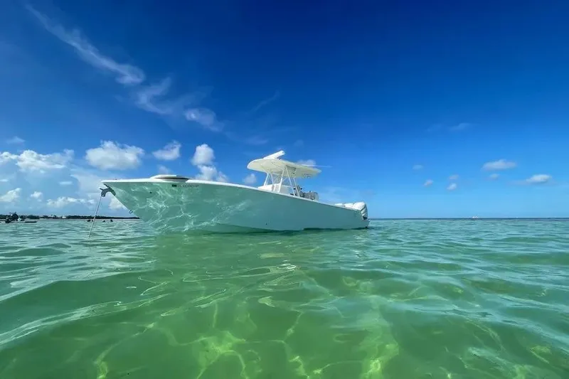 Yacht Photos Pics 2018 SeaVee 340Z boat floating on clear turquoise water under a bright blue sky.