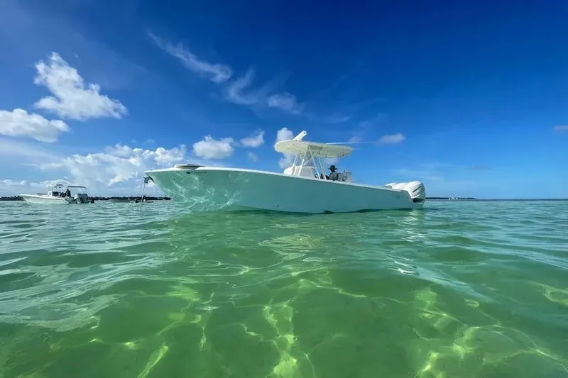  Yacht Photos Pics 2018 SeaVee 340Z boat on clear turquoise water under a bright blue sky.