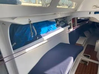 Blue Blazes Yacht Photos Pics Interior of 1992 Reichel/Pugh 50 sailboat with blue cushions and storage compartments.