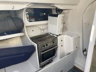 Blue Blazes Yacht Photos Pics 1992 Reichel/Pugh 50 yacht interior with stove, storage, and seating.