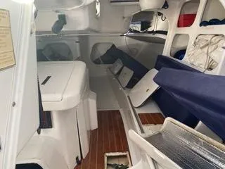 Blue Blazes Yacht Photos Pics Interior of a 1992 Reichel/Pugh 50 sailboat with wooden flooring and blue seating.