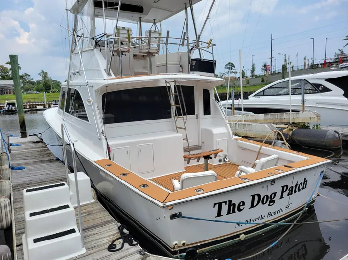 The Dog Patch Yacht Photos Pics 1990 Ocean Yachts 48 Super Sport docked, rear view, named "The Dog Patch," Myrtle Beach, SC.