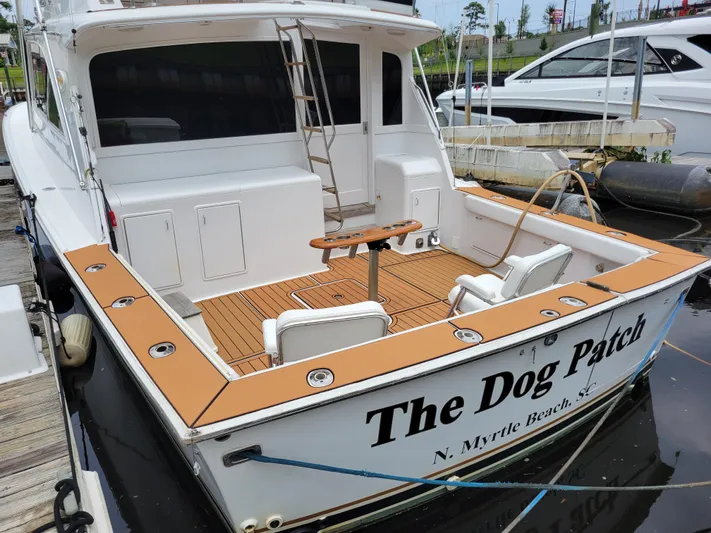 The Dog Patch Yacht Photos Pics 1990 Ocean Yachts 48 Super Sport docked, featuring spacious deck and seating, named "The Dog Patch."