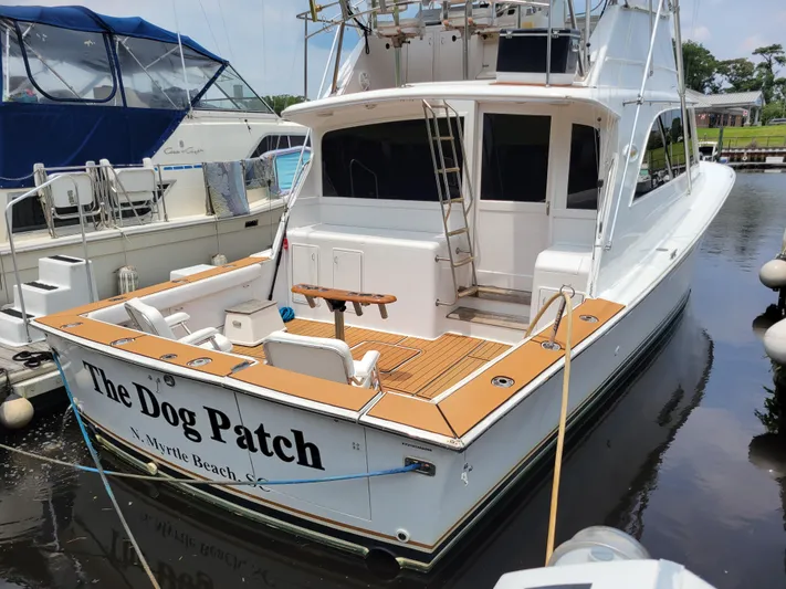 The Dog Patch Yacht Photos Pics Ocean Yachts 1990 48 Super Sport docked, featuring "The Dog Patch" name on stern.
