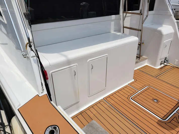The Dog Patch Yacht Photos Pics 1990 Ocean Yachts 48 Super Sport deck with storage compartments and teak flooring.