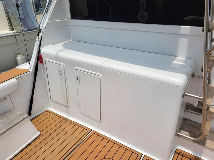 The Dog Patch Yacht Photos Pics 1990 Ocean Yachts 48 Super Sport deck with white seating and storage compartments.