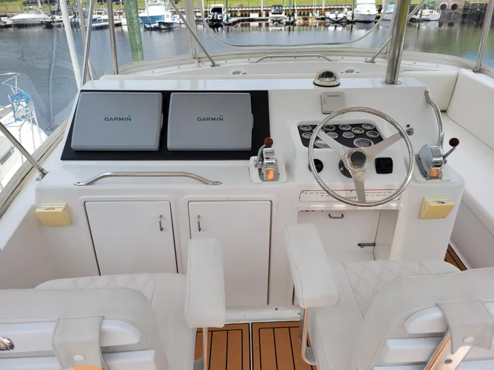 The Dog Patch Yacht Photos Pics 1990 Ocean Yachts 48 Super Sport helm with Garmin displays and steering wheel.