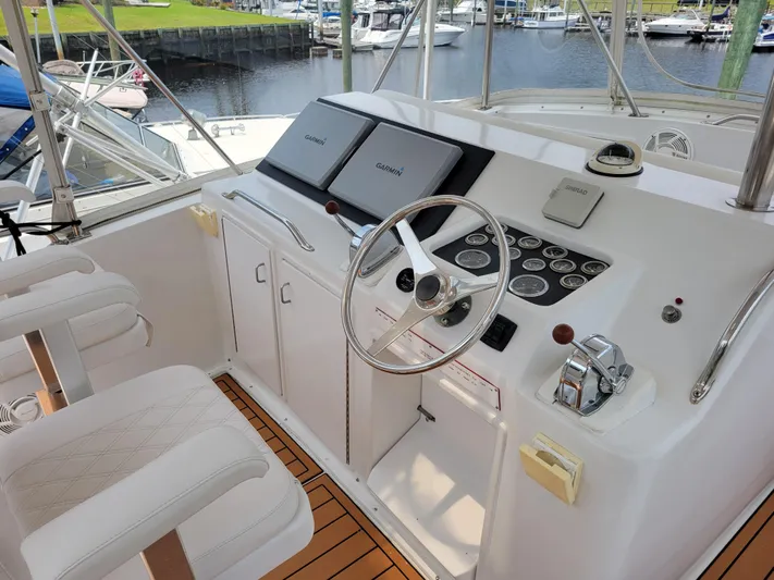 The Dog Patch Yacht Photos Pics Cockpit of 1990 Ocean Yachts 48 Super Sport with steering wheel and navigation equipment.