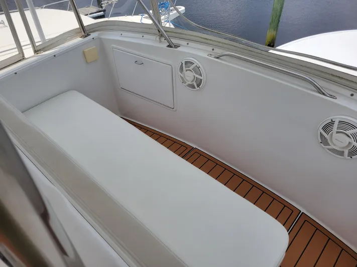 The Dog Patch Yacht Photos Pics 1990 Ocean Yachts 48 Super Sport boat interior with cushioned seating and wooden flooring.