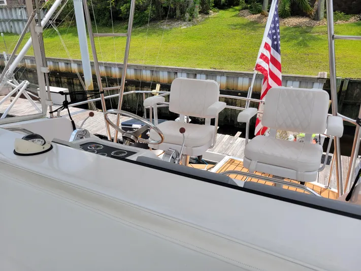 The Dog Patch Yacht Photos Pics 1990 Ocean Yachts 48 Super Sport cockpit with white seats and American flag.