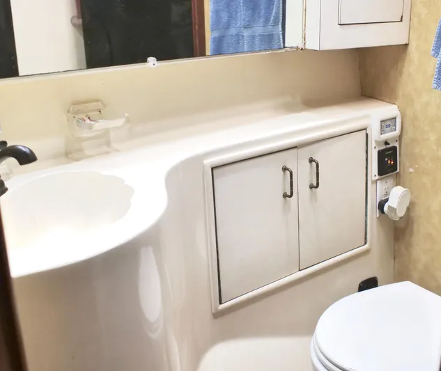 The Dog Patch Yacht Photos Pics Bathroom interior of 1990 Ocean Yachts 48 Super Sport, featuring sink and storage cabinets.