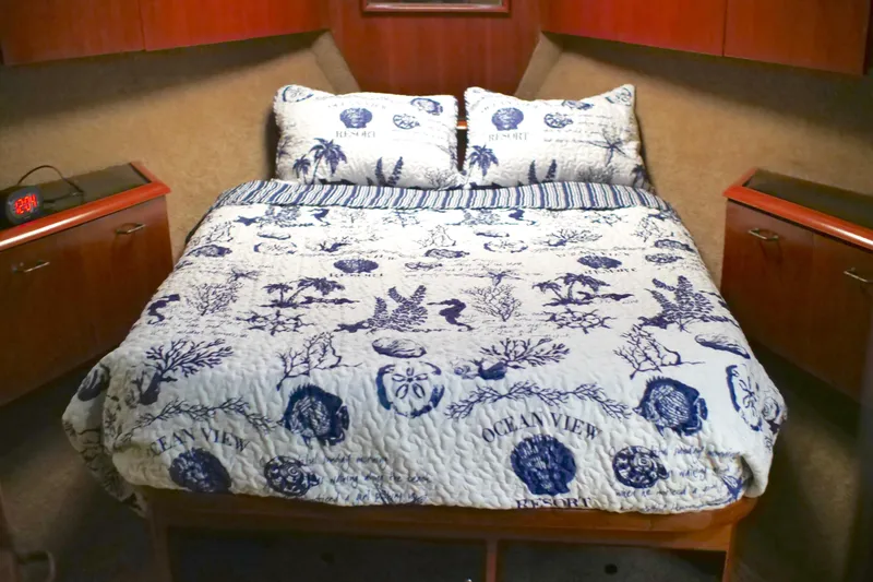 The Dog Patch Yacht Photos Pics Cozy bedroom in 1990 Ocean Yachts 48 Super Sport with nautical-themed bedding.