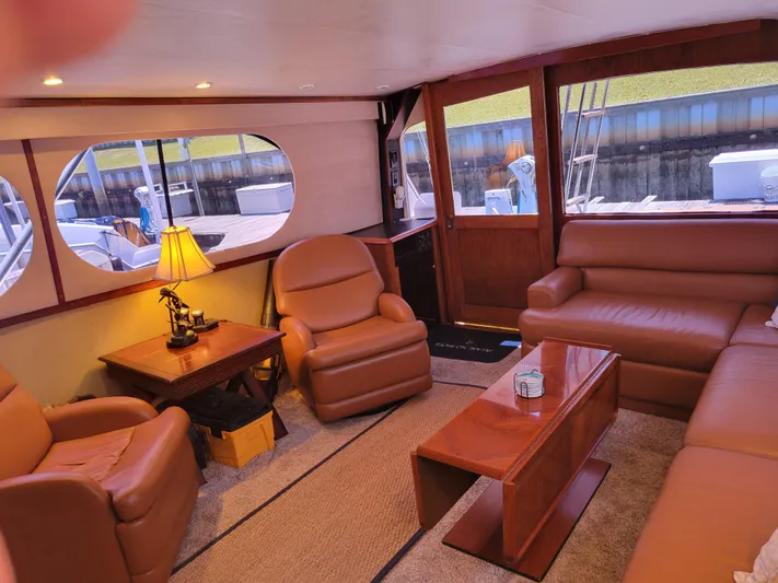 The Dog Patch Yacht Photos Pics Luxurious interior of a 1990 Ocean Yachts 48 Super Sport with leather seating and wooden accents.