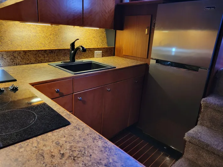 The Dog Patch Yacht Photos Pics 1990 Ocean Yachts 48 Super Sport kitchen with modern appliances and wood cabinetry.