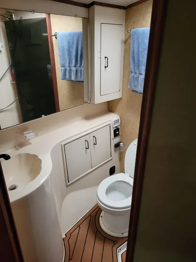The Dog Patch Yacht Photos Pics Bathroom interior of 1990 Ocean Yachts 48 Super Sport with sink, toilet, and storage.