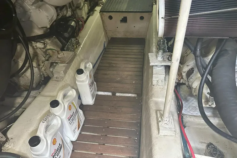 The Dog Patch Yacht Photos Pics Engine room of 1990 Ocean Yachts 48 Super Sport with oil containers and mechanical components.