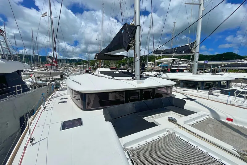 Take It Easy Yacht Photos Pics 2018 Lagoon 450 F catamaran docked in a marina under a blue sky.