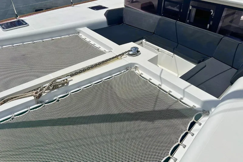 Take It Easy Yacht Photos Pics 2018 Lagoon 450 F catamaran deck with netting and seating area.