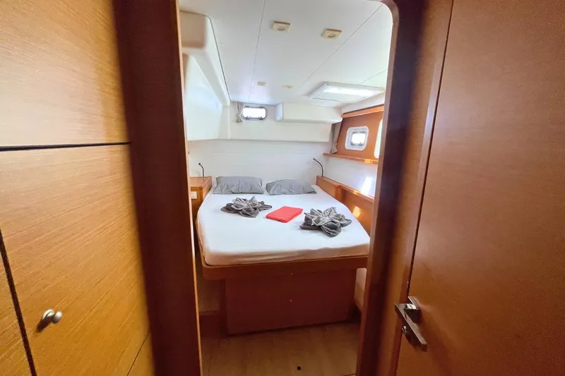 Take It Easy Yacht Photos Pics Cozy cabin interior of 2018 Lagoon 450 F catamaran with neatly arranged bed.