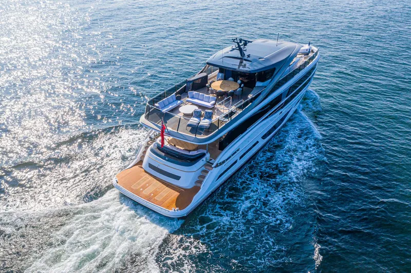  Yacht Photos Pics Luxurious 2025 Princess X95 yacht cruising on open water, aerial view.