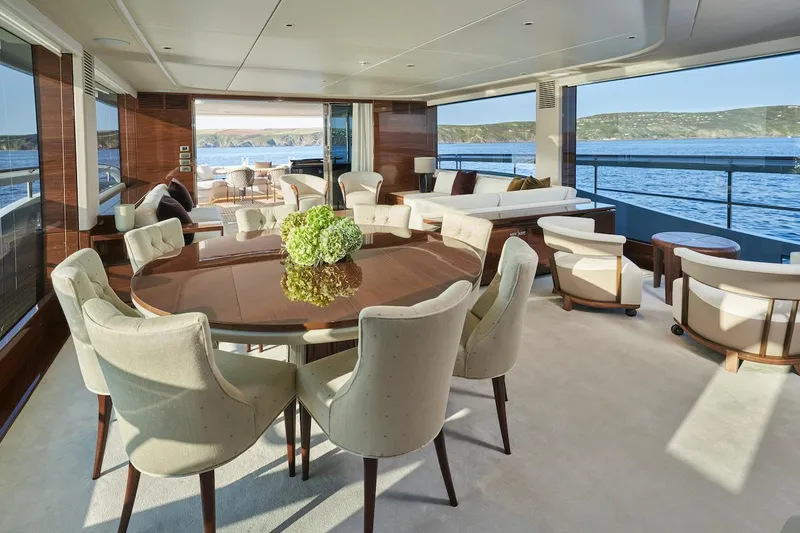  Yacht Photos Pics Luxurious interior of 2025 Princess X95 yacht with elegant dining area and ocean view.