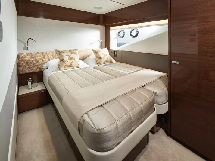  Yacht Photos Pics Luxurious bedroom interior of 2025 Princess X95 yacht with elegant bedding and wood accents.