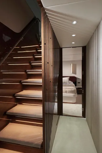  Yacht Photos Pics Luxurious interior of 2025 Princess X95 yacht, featuring elegant staircase and modern bedroom.