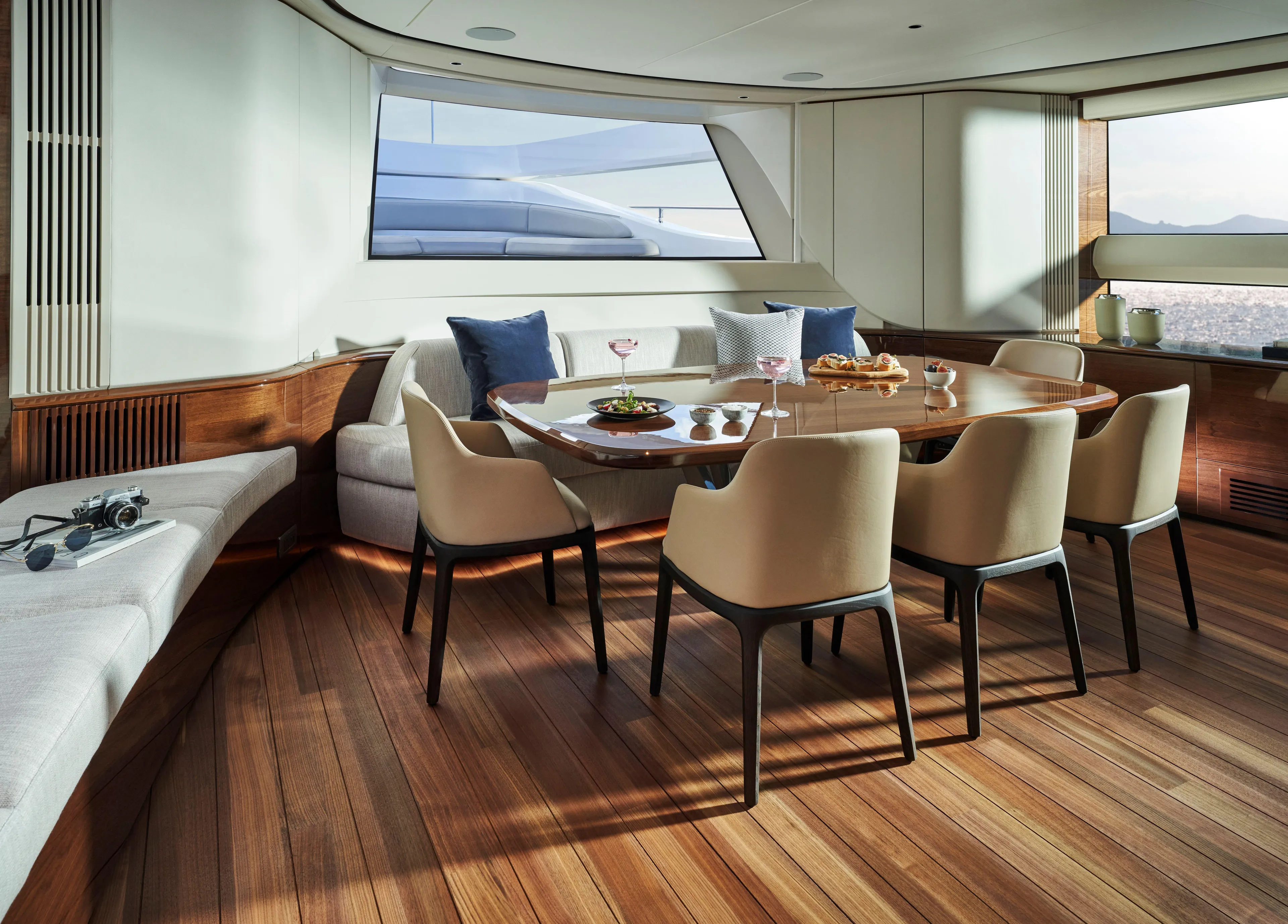 Yacht Photos Pics Luxurious dining area on 2025 Princess X95 yacht with elegant seating and wooden flooring.