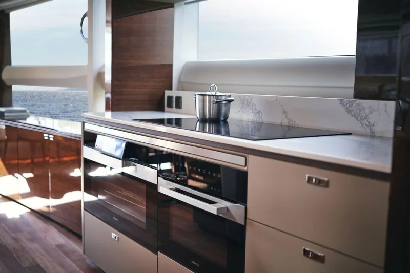  Yacht Photos Pics Modern kitchen interior on 2025 Princess X95 yacht, featuring sleek appliances and ocean view.