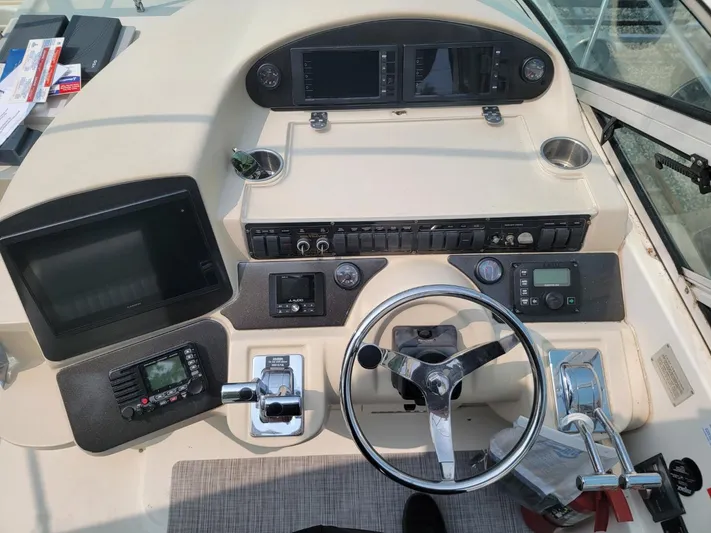  Yacht Photos Pics Cockpit of 2000 Cruisers 3870 Express with steering wheel and navigation controls.