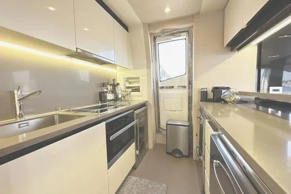  Yacht Photos Pics Modern kitchen interior on a 2015 Azimut 80 yacht, featuring sleek cabinetry and stainless steel appliances.