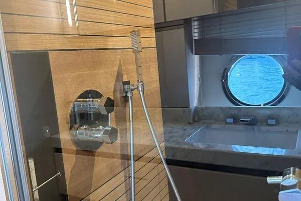  Yacht Photos Pics Luxurious bathroom interior of 2015 Azimut 80 yacht with ocean view porthole.