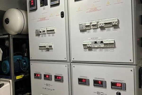  Yacht Photos Pics Electrical control panel of a 2015 Azimut 80 yacht, featuring circuit breakers and digital displays.