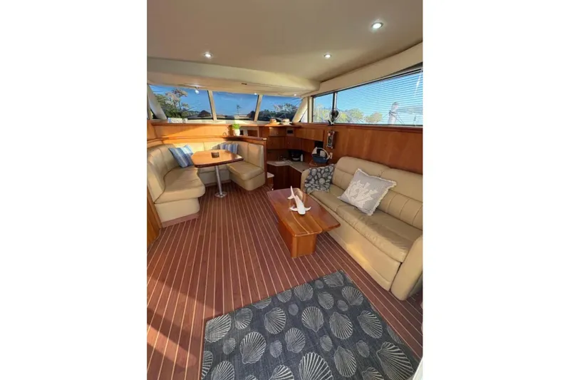  Yacht Photos Pics Luxurious interior of 2003 Silverton 42 Convertible yacht with plush seating and elegant decor.