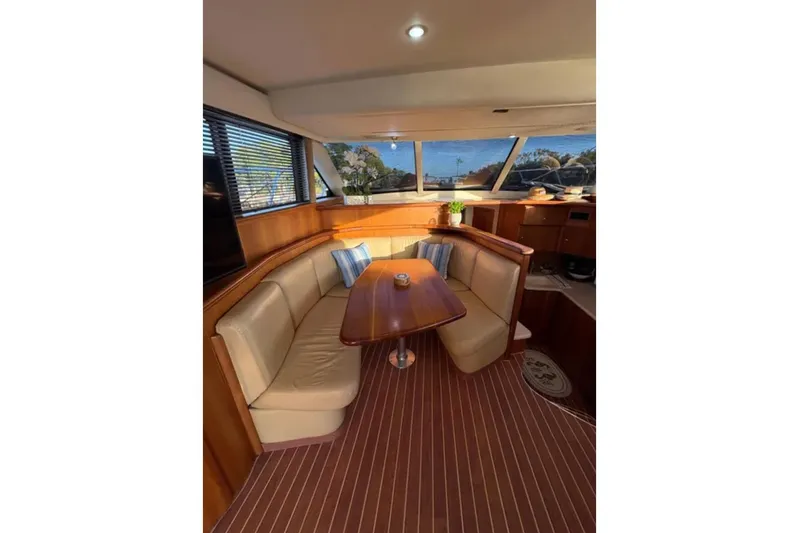  Yacht Photos Pics Interior of 2003 Silverton 42 Convertible yacht with cozy seating and wooden accents.