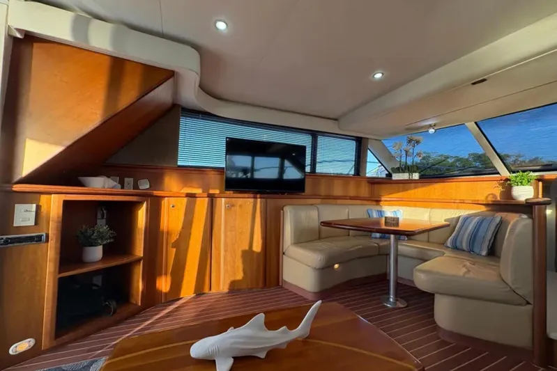  Yacht Photos Pics Luxurious interior of a 2003 Silverton 42 Convertible yacht with cozy seating and modern decor.